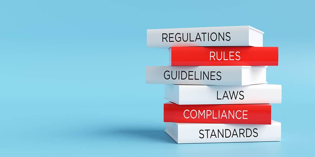 Stack of books representing regulatory compliance and legal standards