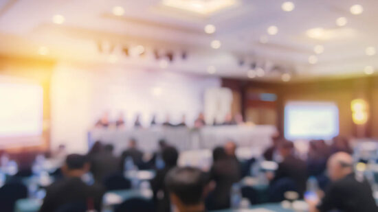 Defocused Image Of Business People At Seminar