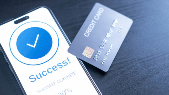 smartphone screen shows a successful payment confirmation, with a credit card. The image emphasizes digital payments, financial technology, and the convenience of secure mobile transactions.