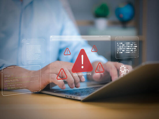 Cybersecurity, virus protection, Hand on laptop with holographic System warning and red alert icons. Symbolizes cyber threats, data security breaches, and IT system errors. digital risk management now