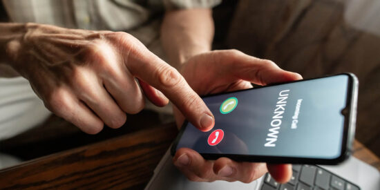 Senior man refuses to answer to a call from unknown number. Scam and fraud prevention with smartphone concept.